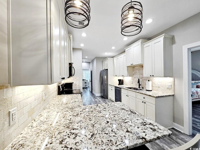 kitchen featuring dark wood-style floors, white cabinets, a sink, light stone countertops, and black appliances