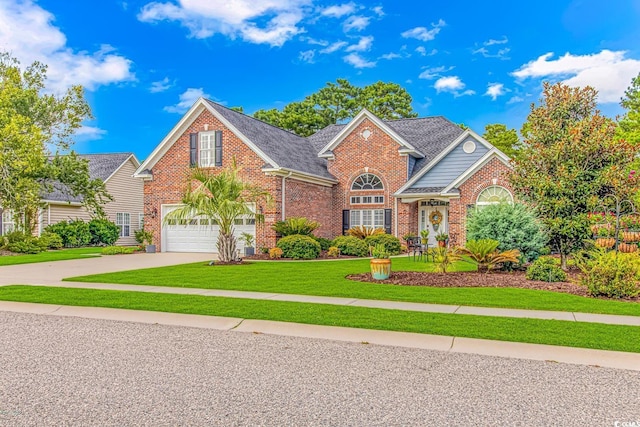 traditional-style home featuring a garage, brick siding, driveway, roof with shingles, and a front lawn