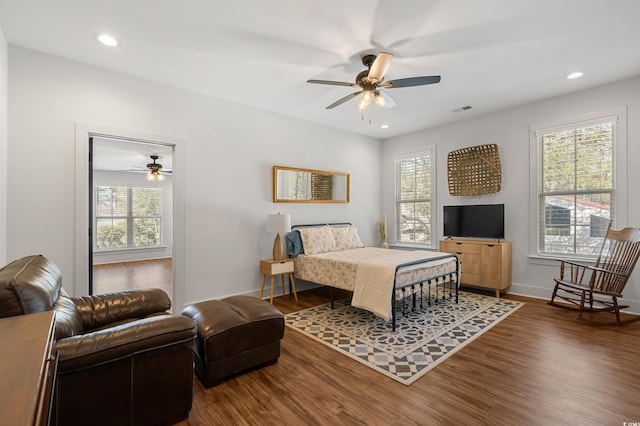 bedroom featuring baseboards, visible vents, wood finished floors, and recessed lighting