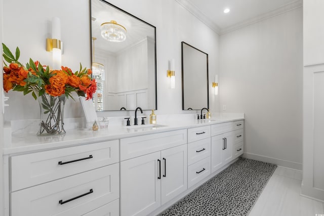 full bathroom with ornamental molding, a sink, baseboards, and double vanity