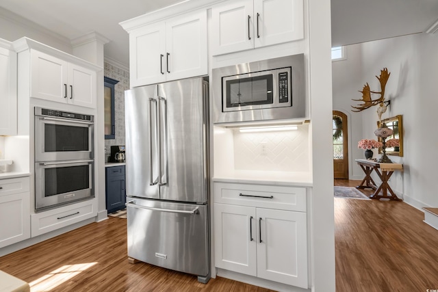 kitchen with light countertops, appliances with stainless steel finishes, and wood finished floors