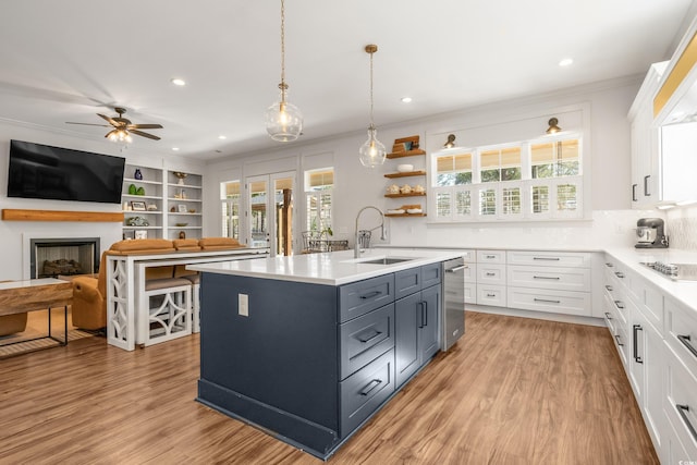 kitchen with light countertops, a sink, and white cabinets