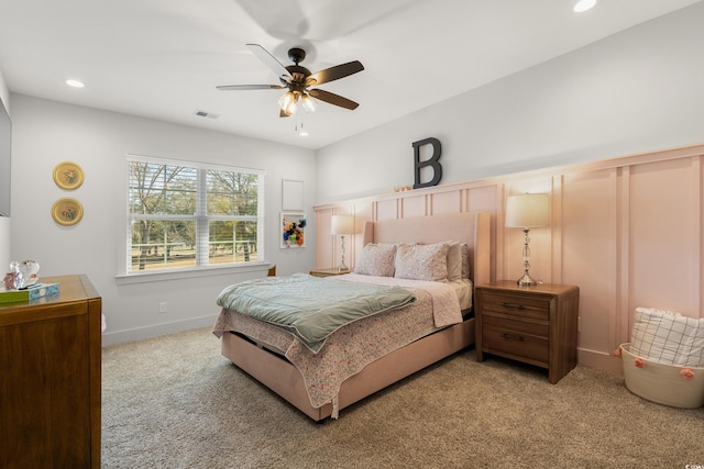 carpeted bedroom featuring baseboards, recessed lighting, visible vents, and a ceiling fan