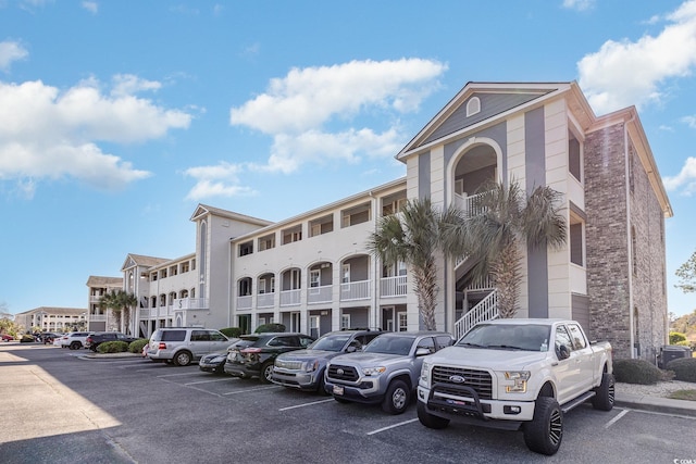 view of property featuring uncovered parking