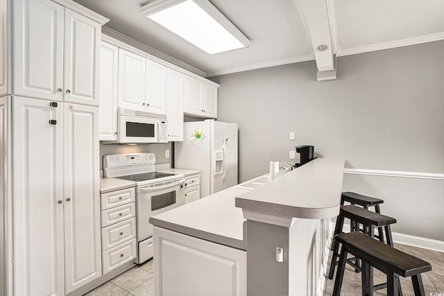 4503 W Harbour Ct Unit S-6, Little River, SC 29566 - kitchen featuring white appliances, ornamental molding, a breakfast bar area, white cabinetry, and light tile patterned floors