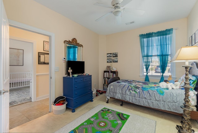 bedroom with a ceiling fan, tile patterned flooring, and visible vents