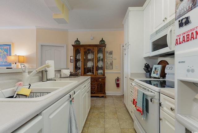 kitchen with white appliances, ornamental molding, light countertops, and a sink