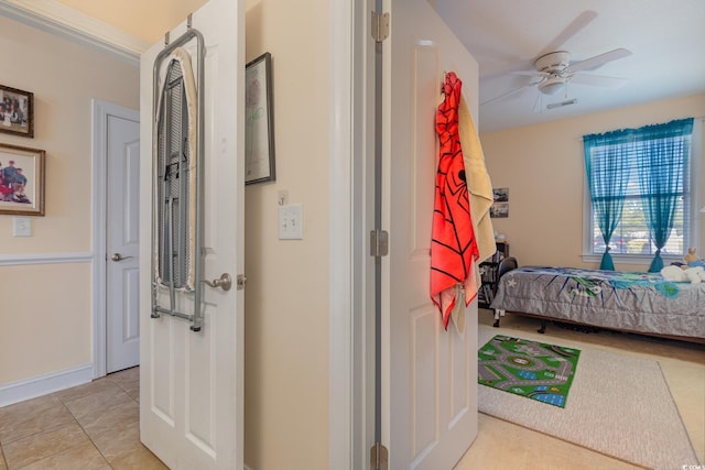 interior space featuring light tile patterned flooring, visible vents, and baseboards