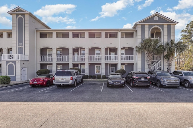 view of building exterior with uncovered parking