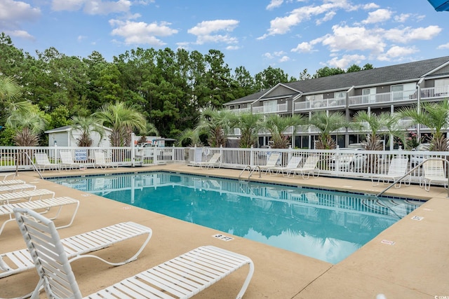 pool featuring a patio area and fence