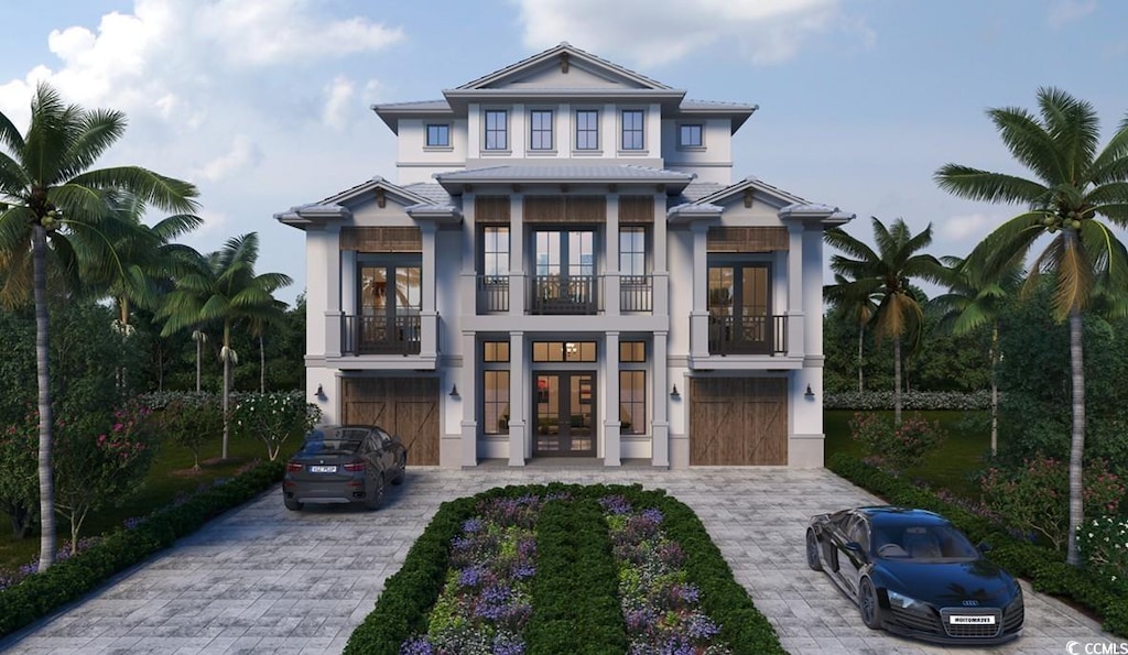 view of front facade with decorative driveway, french doors, stucco siding, a balcony, and a garage