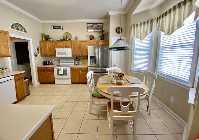 kitchen featuring white appliances, light tile patterned floors, ornamental molding, and light countertops