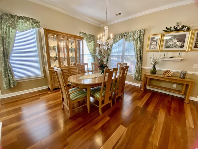 dining area featuring a notable chandelier, visible vents, ornamental molding, wood finished floors, and baseboards