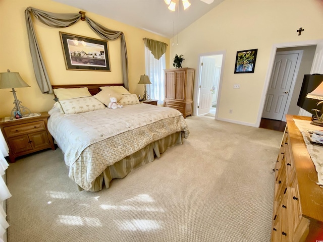 bedroom featuring high vaulted ceiling, light carpet, and baseboards