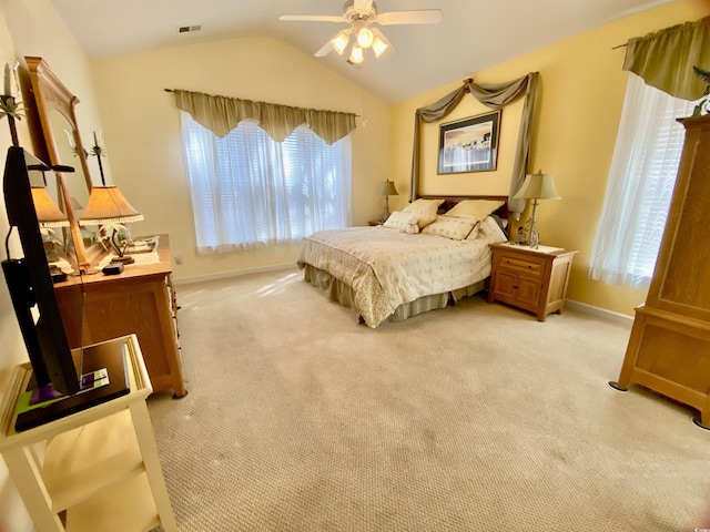 bedroom with vaulted ceiling, multiple windows, and light colored carpet