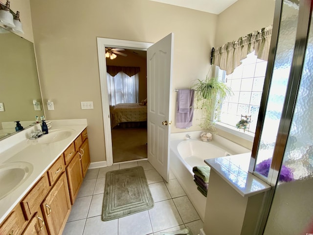 full bathroom with a sink, plenty of natural light, tile patterned flooring, and a bath