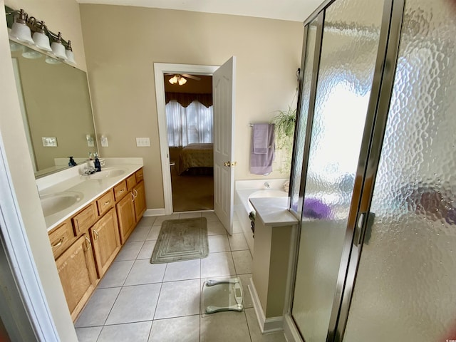 bathroom featuring a sink, tile patterned flooring, connected bathroom, and a shower stall