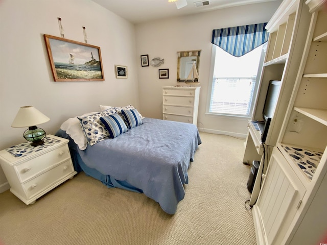 bedroom featuring baseboards, visible vents, and light colored carpet