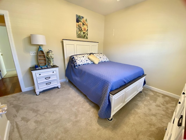 bedroom with light carpet and baseboards