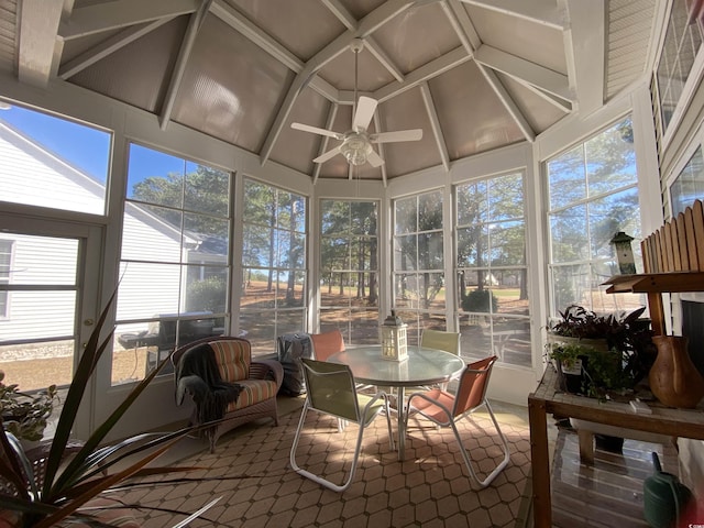 sunroom / solarium featuring a ceiling fan, coffered ceiling, and vaulted ceiling with beams