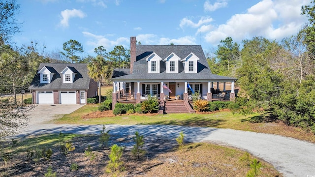 view of front facade with covered porch, a front yard, and a garage