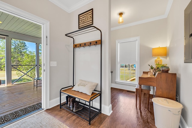 entryway with baseboards, wood-type flooring, visible vents, and crown molding