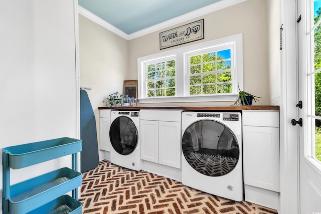 laundry area with cabinet space, ornamental molding, and brick floor