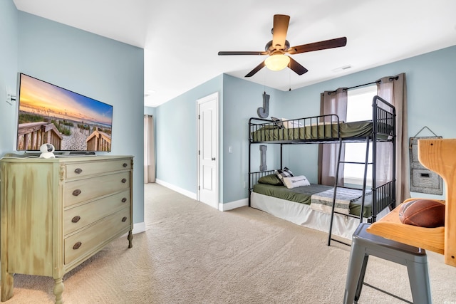 bedroom with visible vents, ceiling fan, light carpet, and baseboards