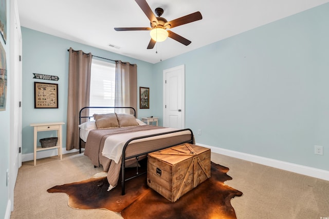 bedroom with ceiling fan, carpet flooring, visible vents, and baseboards