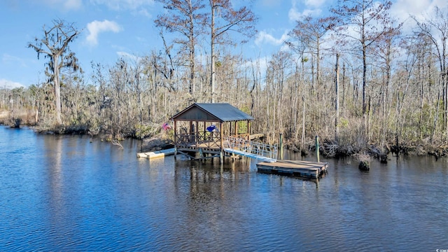 dock area with a water view and a wooded view