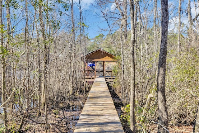 view of dock with a wooded view