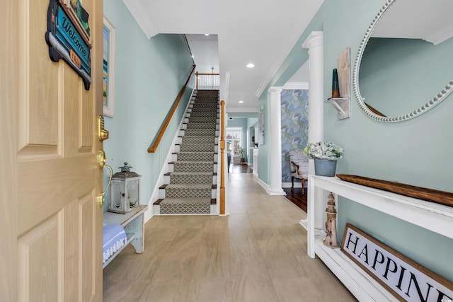 foyer entrance with ornamental molding, recessed lighting, and ornate columns