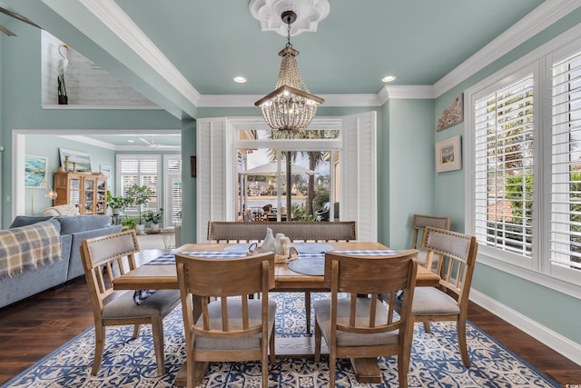 dining space featuring dark wood-style floors, baseboards, and crown molding