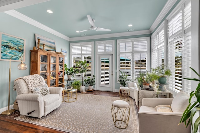 sitting room featuring crown molding, visible vents, a ceiling fan, wood finished floors, and baseboards