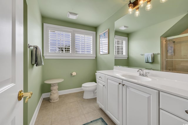 bathroom featuring toilet, vanity, baseboards, visible vents, and tile patterned floors