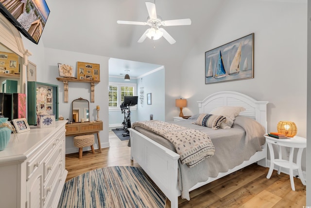 bedroom featuring a ceiling fan, light wood-style flooring, and baseboards