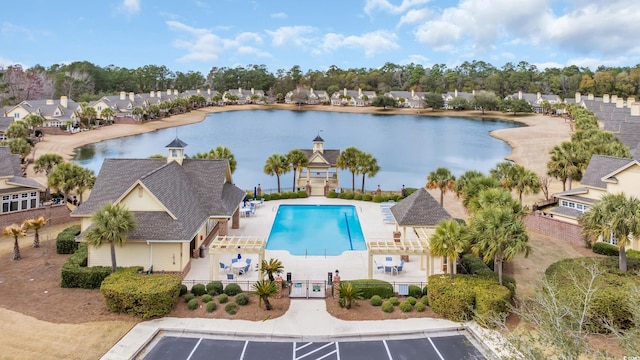 drone / aerial view with a water view and a residential view