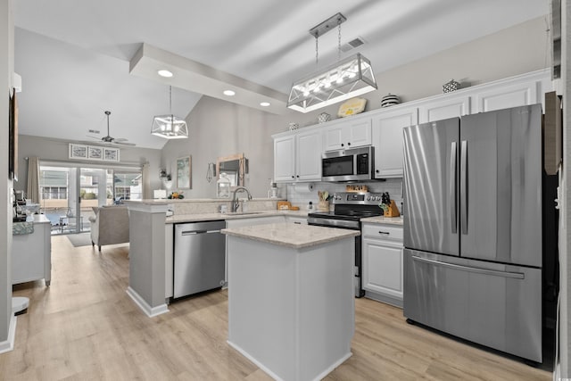 kitchen featuring appliances with stainless steel finishes, visible vents, a peninsula, and white cabinetry