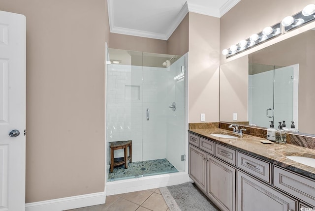 bathroom featuring ornamental molding, a sink, a shower stall, and tile patterned floors