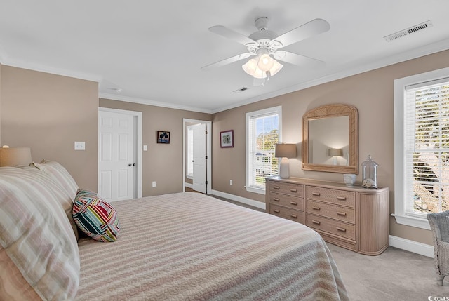 bedroom with baseboards, light carpet, visible vents, and crown molding