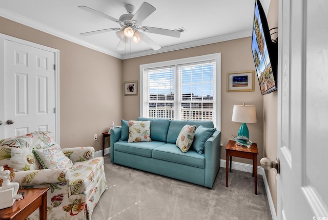 living room featuring ornamental molding, light carpet, ceiling fan, and baseboards