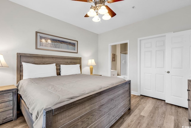 bedroom featuring baseboards, ceiling fan, ensuite bath, and wood finished floors