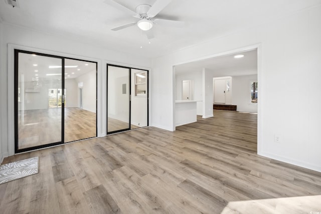 unfurnished room with ceiling fan and wood finished floors