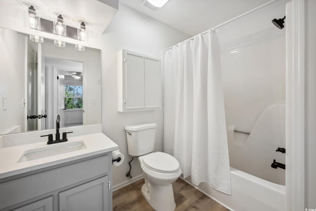full bath featuring shower / bath combo, vanity, toilet, and wood finished floors