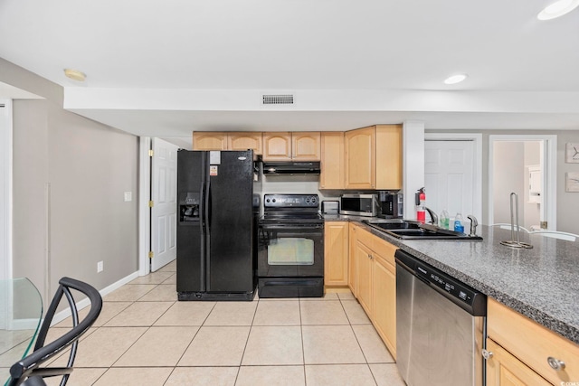 kitchen featuring dark countertops, visible vents, light brown cabinetry, under cabinet range hood, and black appliances