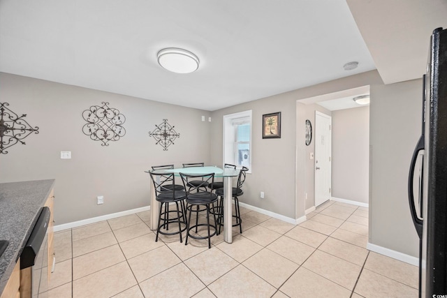 dining area with light tile patterned floors and baseboards