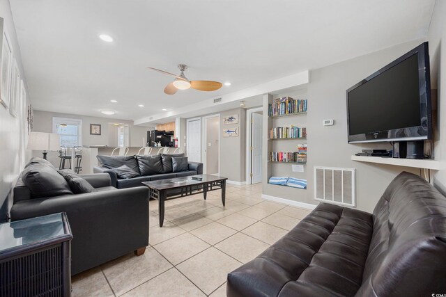 living room featuring light tile patterned floors, a ceiling fan, visible vents, and recessed lighting