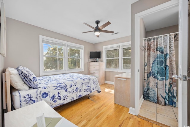 bedroom with wood finished floors, baseboards, and a ceiling fan