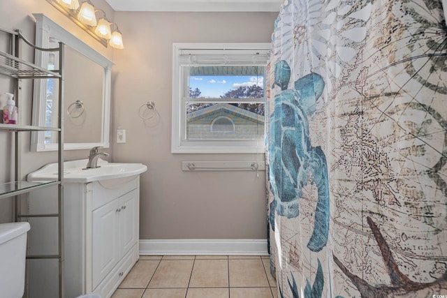 bathroom with toilet, tile patterned flooring, baseboards, and vanity