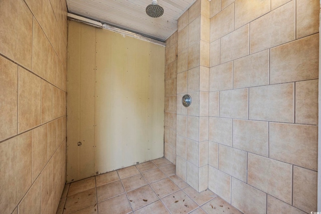 bathroom with tile patterned floors, wood ceiling, and a tile shower